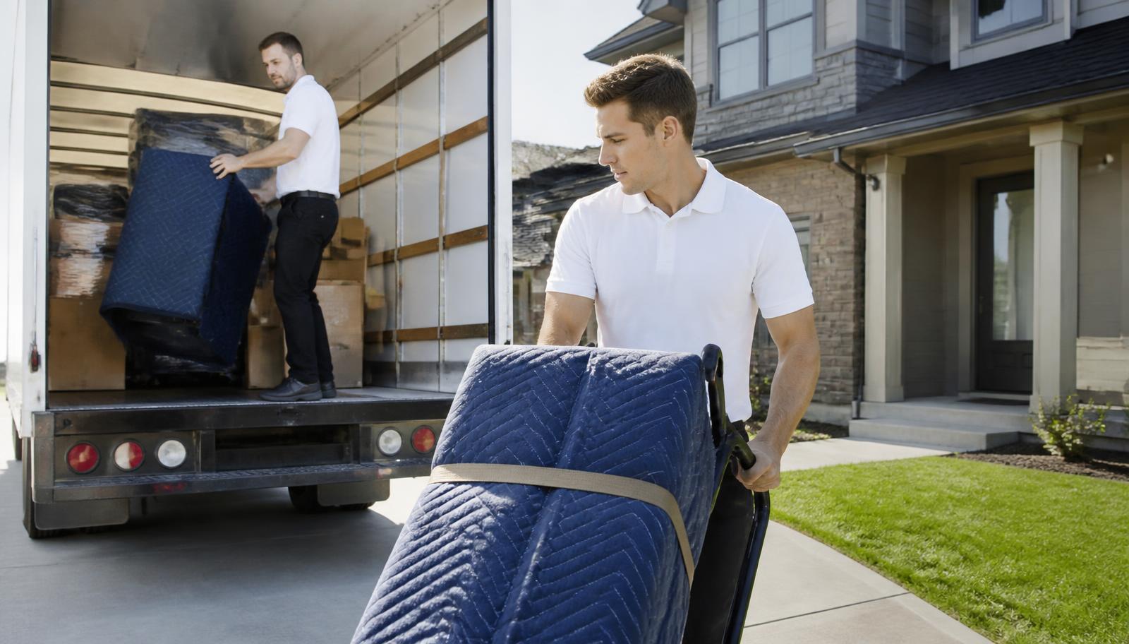 Movers loading a customer-rented moving truck in a Northern Colorado driveway